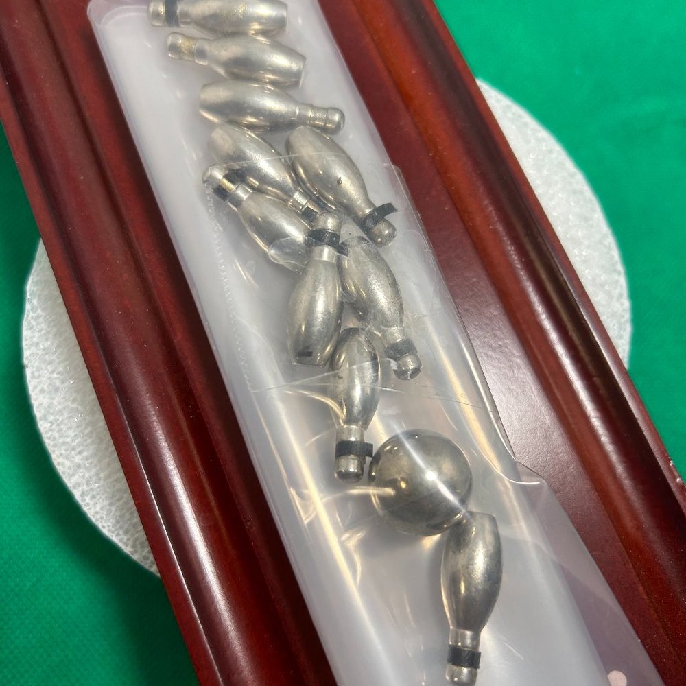 Desktop bowling game. Includes 10 metal pins and ball. 12" x 3-3/4".  (470)